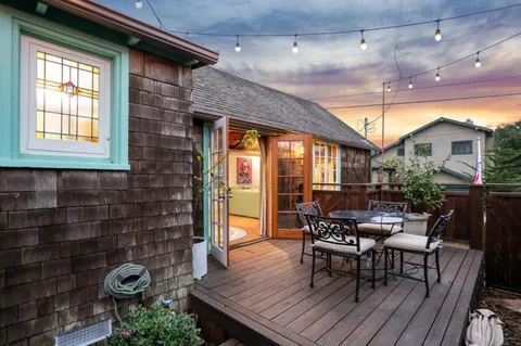 a view of a patio with table and chairs and potted plants