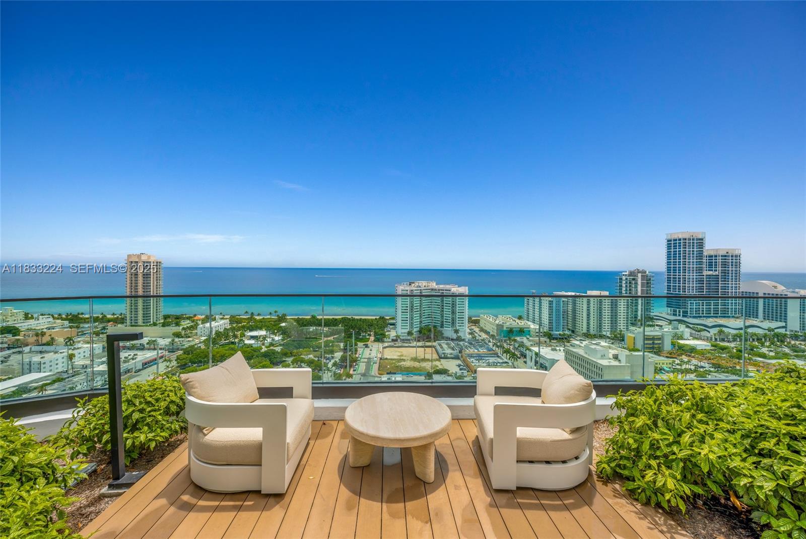 580 72nd Street, Unit 910 Miami Beach, FL 33141 - Photo 8 of 60 a view of a roof deck with couches and potted plants