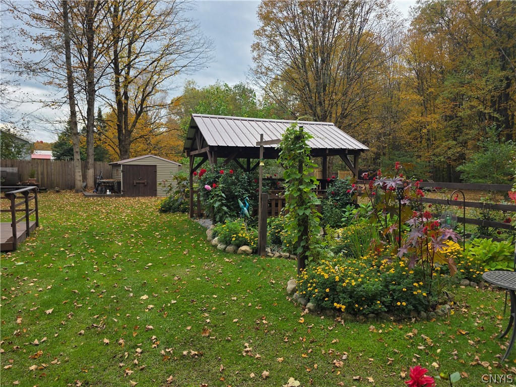1053 Grant Road Russia, NY 13324 - Photo 30 of 47 Mature trees frame a lush backyard garden featurin