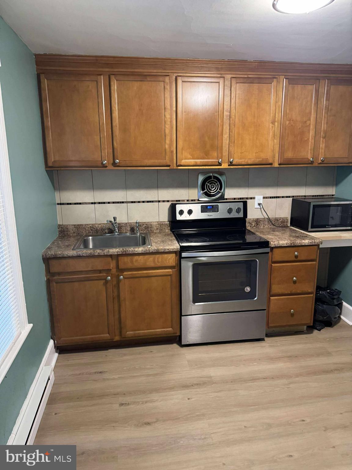 a kitchen with a stove and a sink
