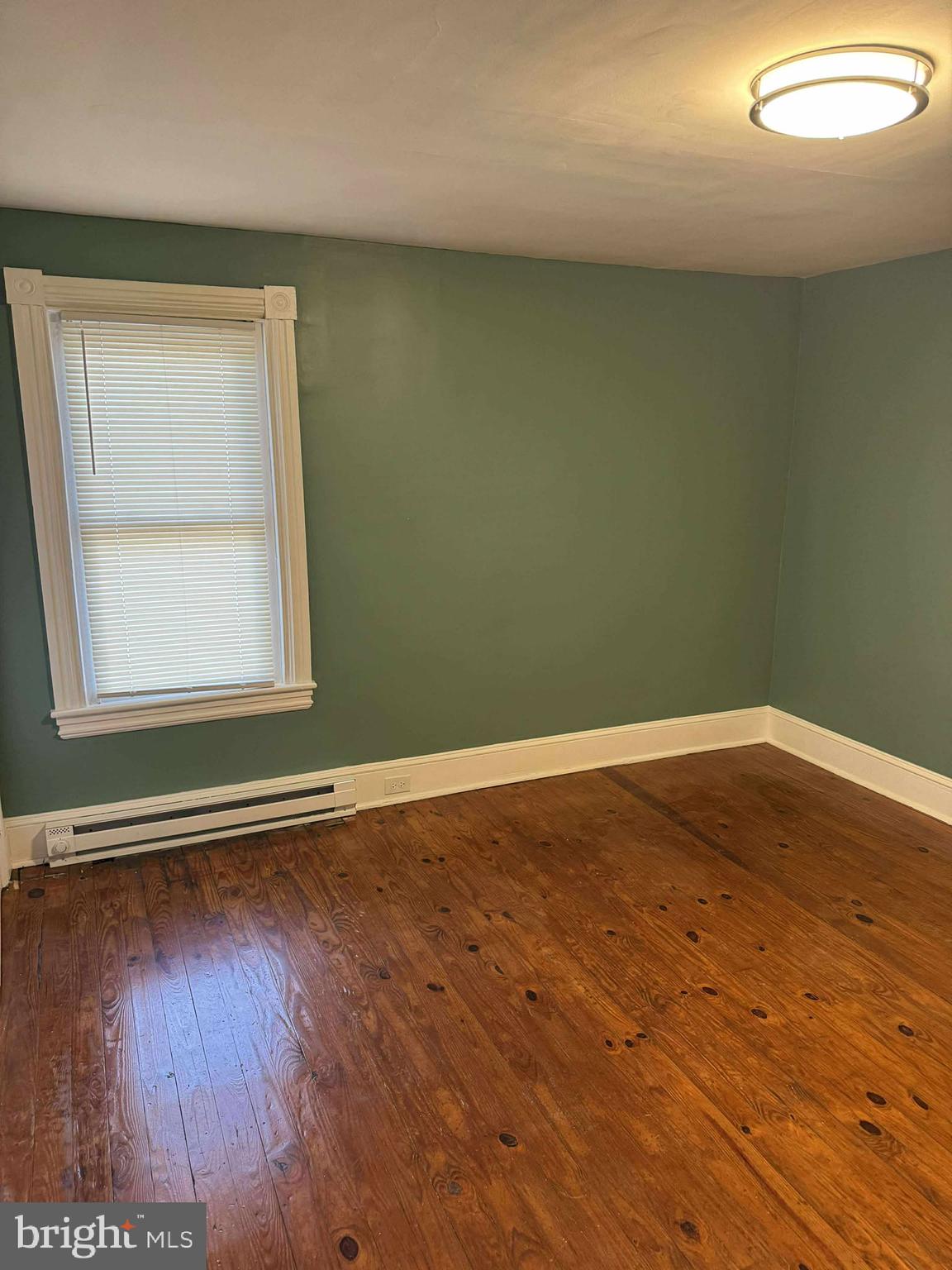 1931 Valley Road, Unit 2 Parkesburg, PA 19365 - Photo 2 of 10 an empty room with wooden floor and windows