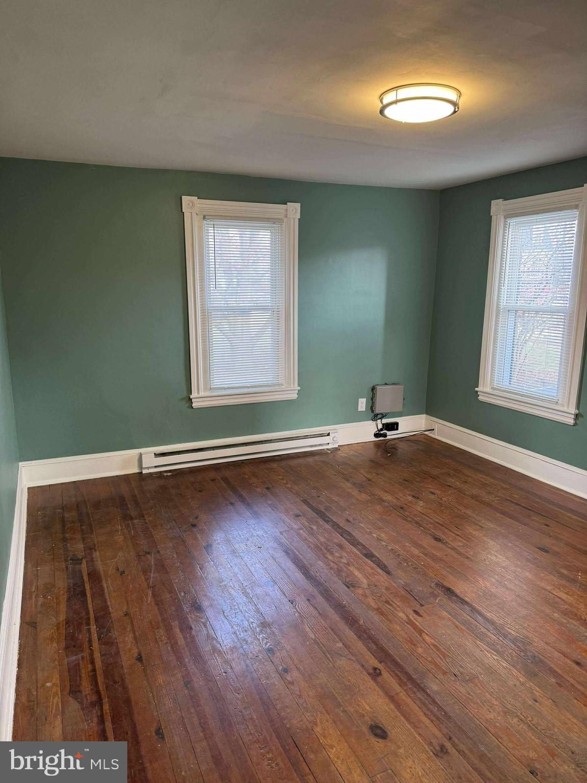 1931 Valley Road, Unit 2 Parkesburg, PA 19365 - Photo 8 of 10 an empty room with wooden floor and windows