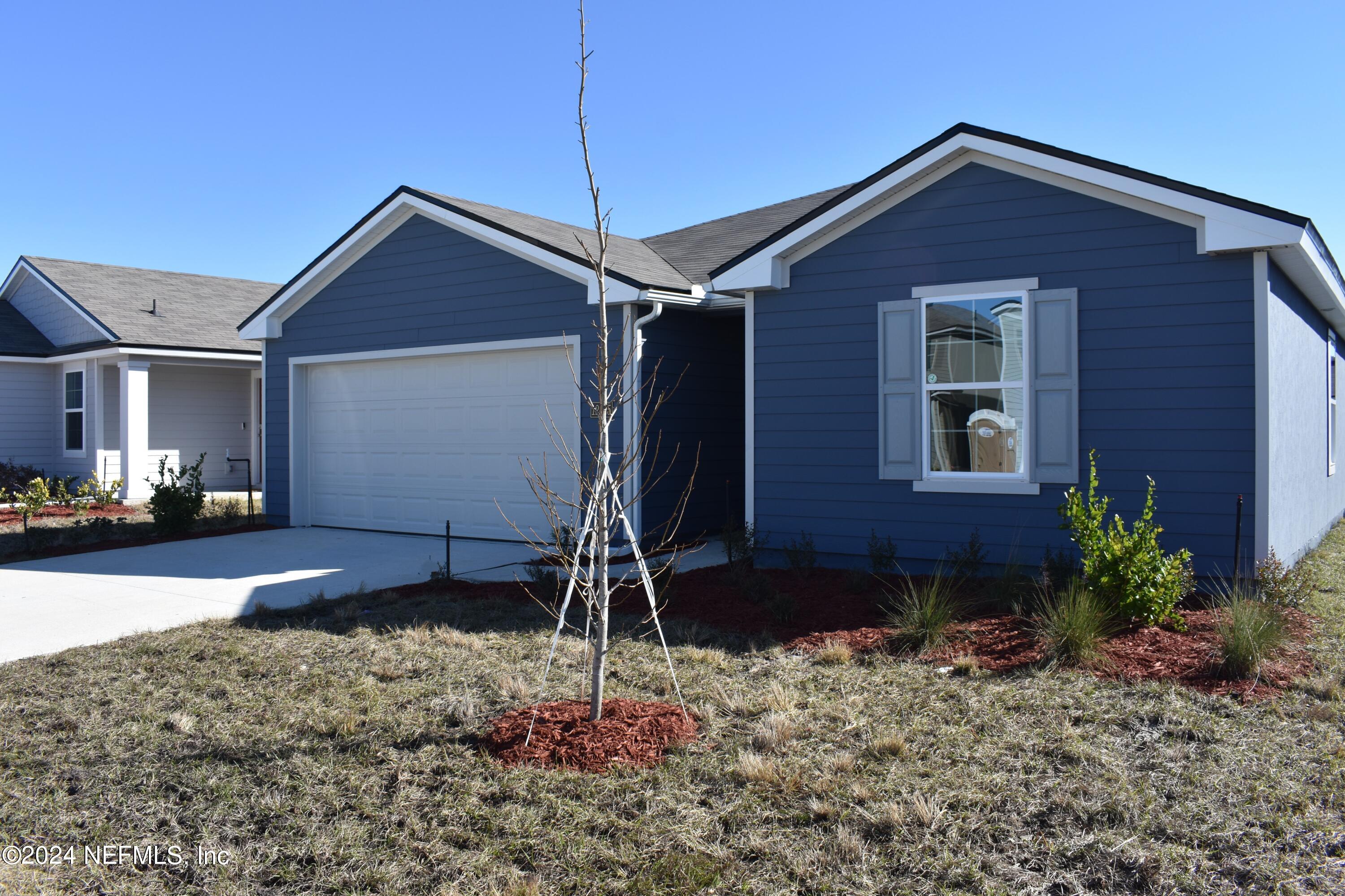 12725 European Beech Road Jacksonville, FL 32218 - Photo 1 of 36 a front view of a house with garden