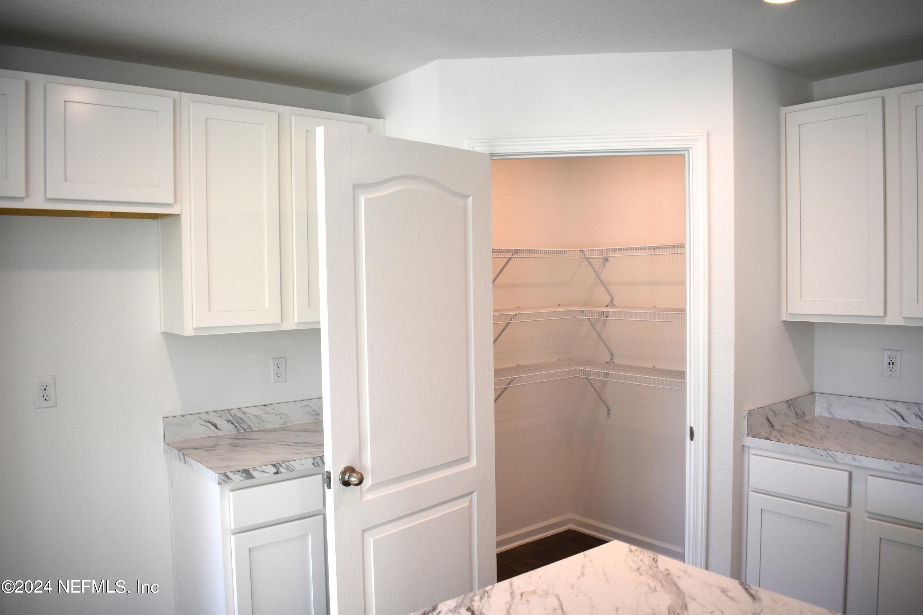 12725 European Beech Road Jacksonville, FL 32218 - Photo 11 of 36 a walk in closet with wooden floor