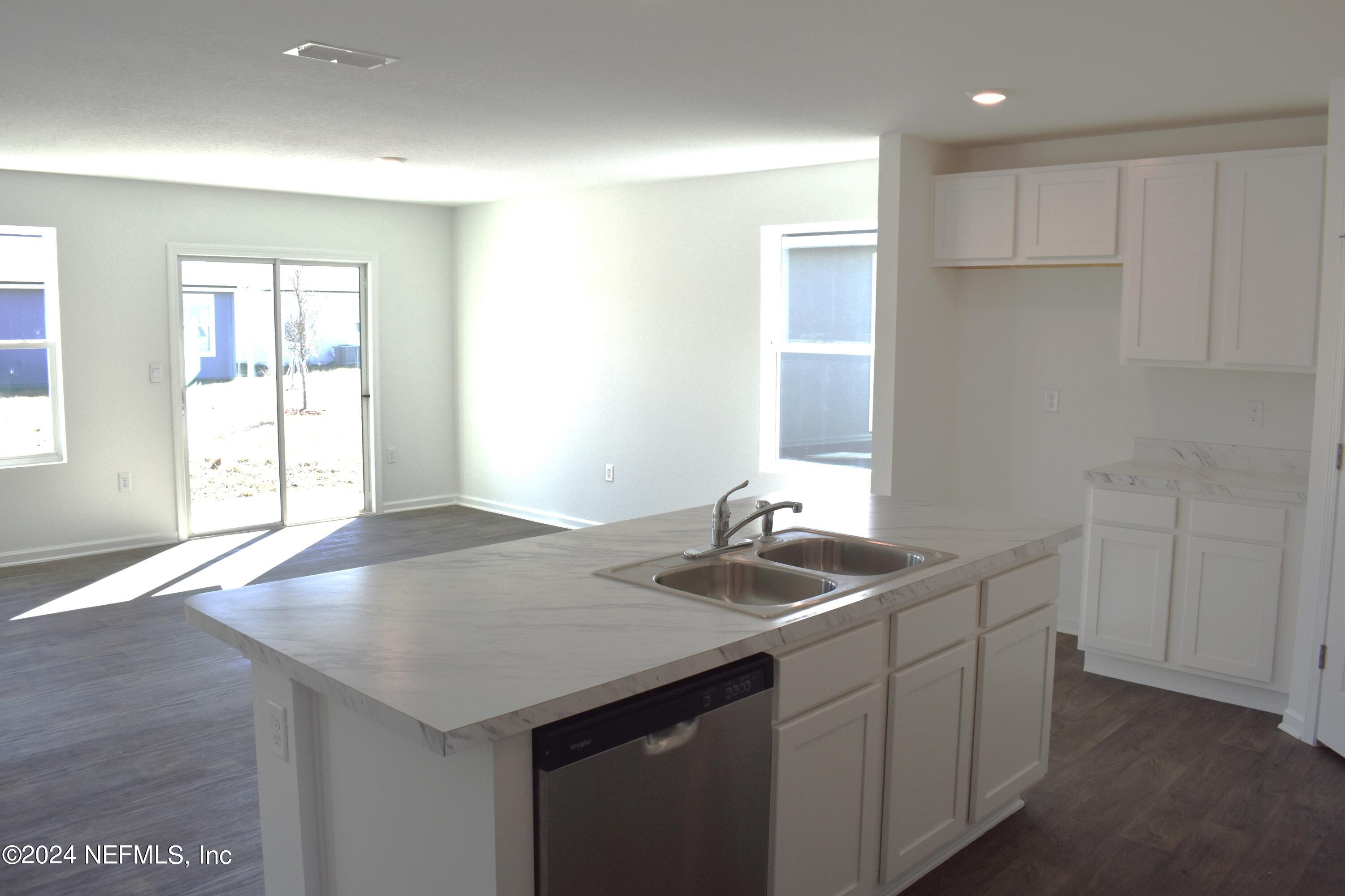 12725 European Beech Road Jacksonville, FL 32218 - Photo 12 of 36 a kitchen with a sink cabinets and a granite counter tops