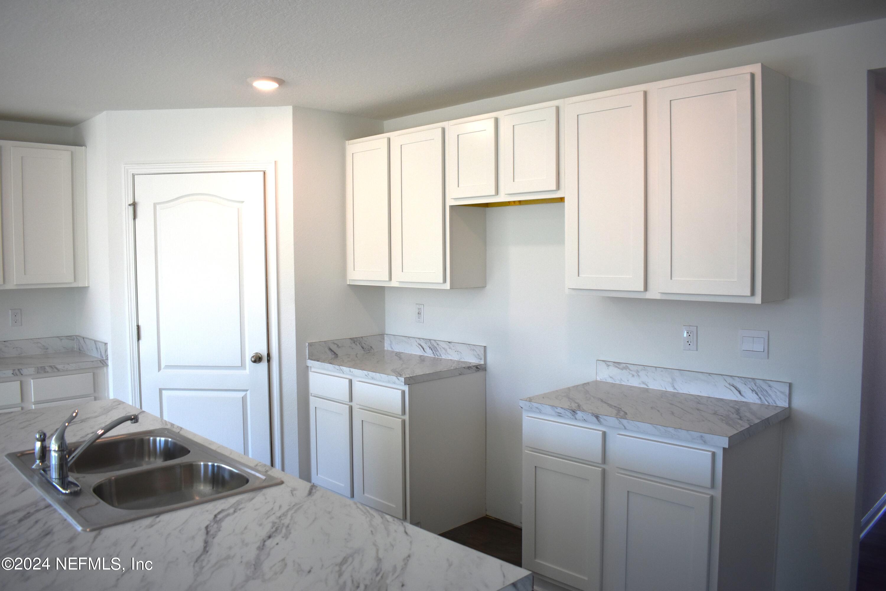 12725 European Beech Road Jacksonville, FL 32218 - Photo 13 of 36 a kitchen with a sink cabinets and window