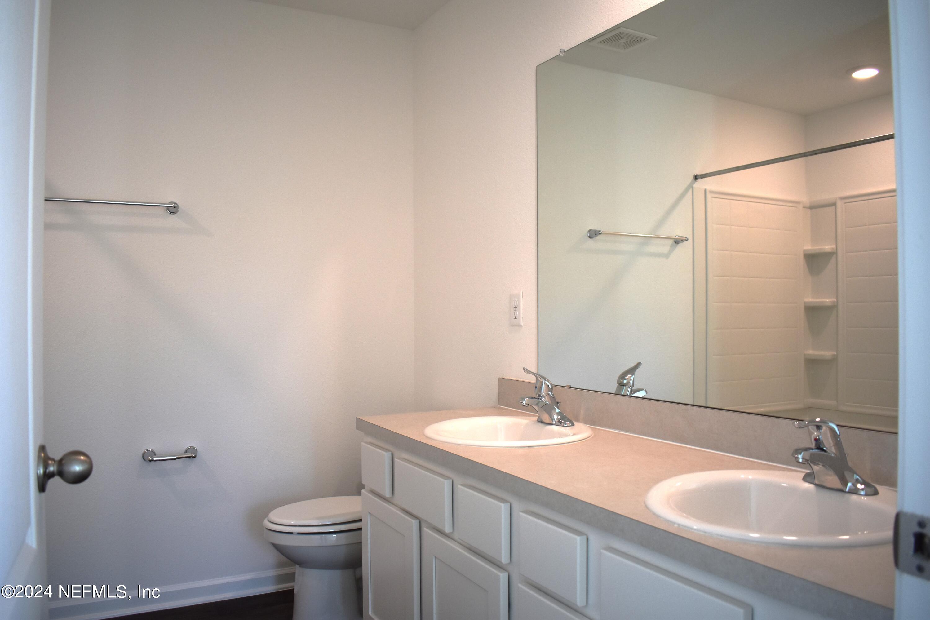 12725 European Beech Road Jacksonville, FL 32218 - Photo 18 of 36 a bathroom with a sink toilet and shower