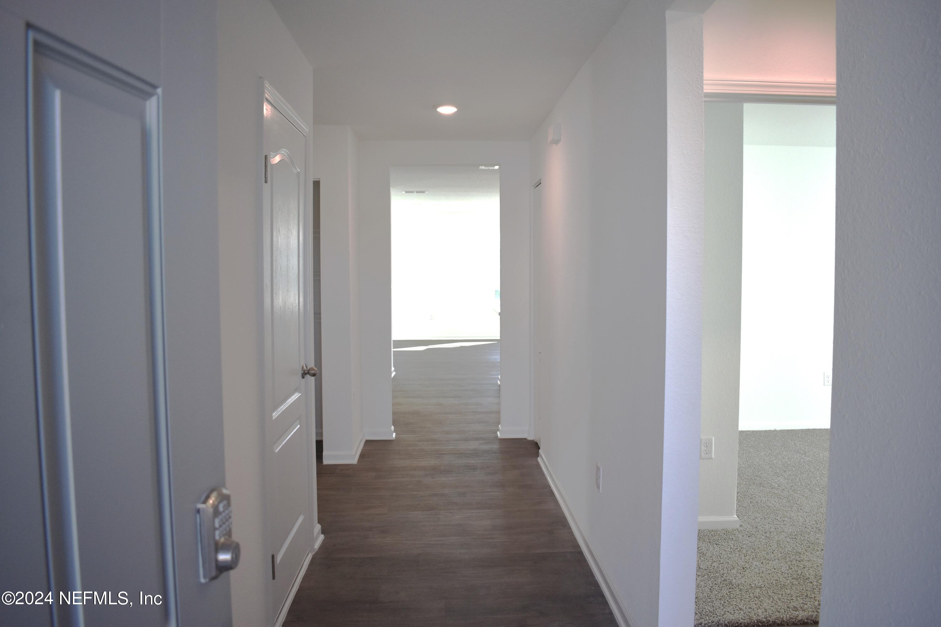 12725 European Beech Road Jacksonville, FL 32218 - Photo 4 of 36 a view of a hallway with the wooden floor