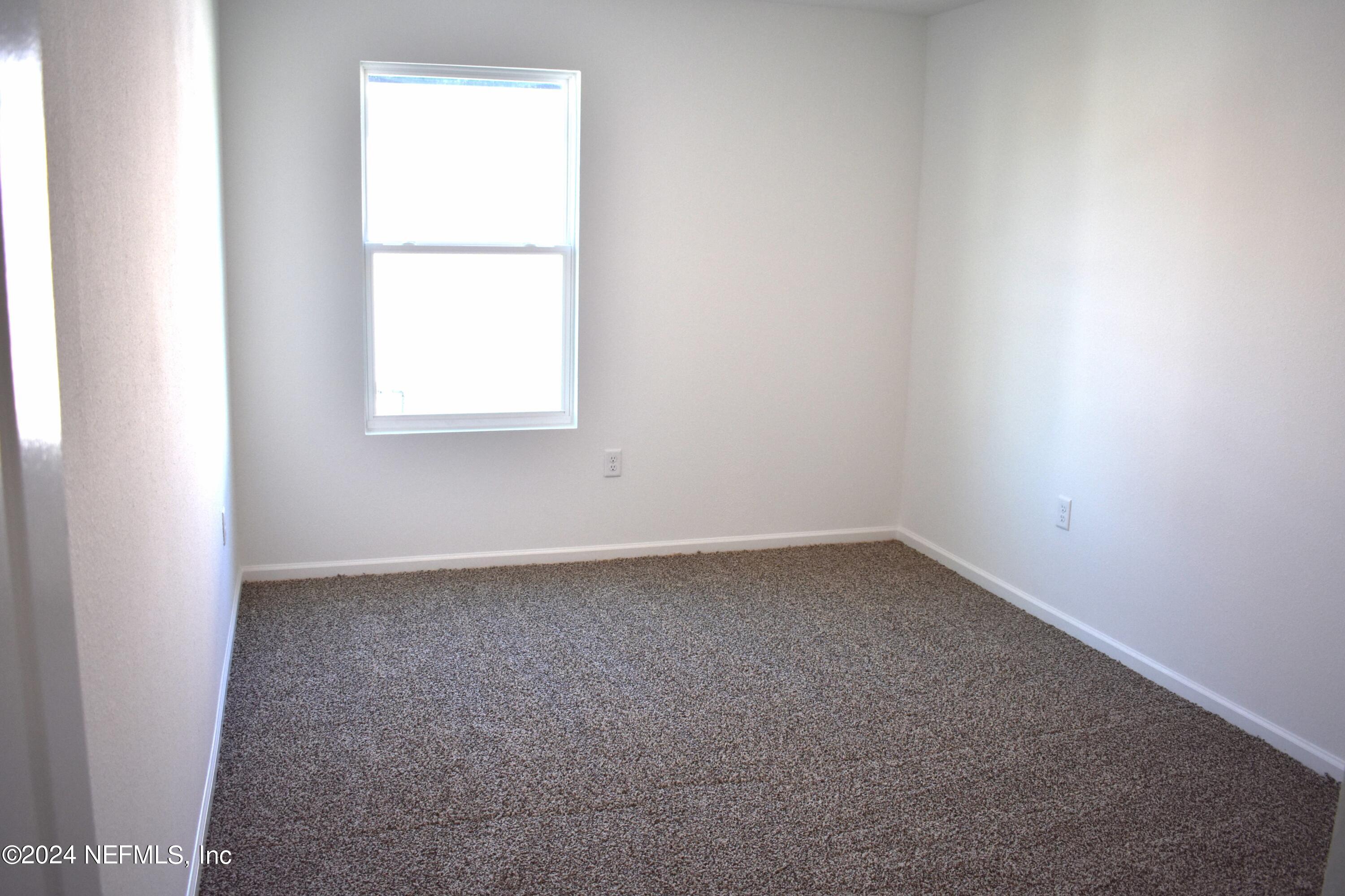 12725 European Beech Road Jacksonville, FL 32218 - Photo 8 of 36 an empty room with a window
