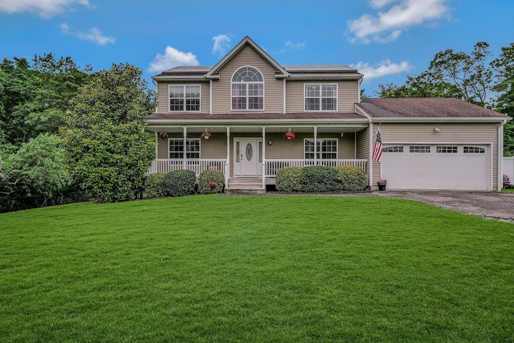 a front view of a house with a garden