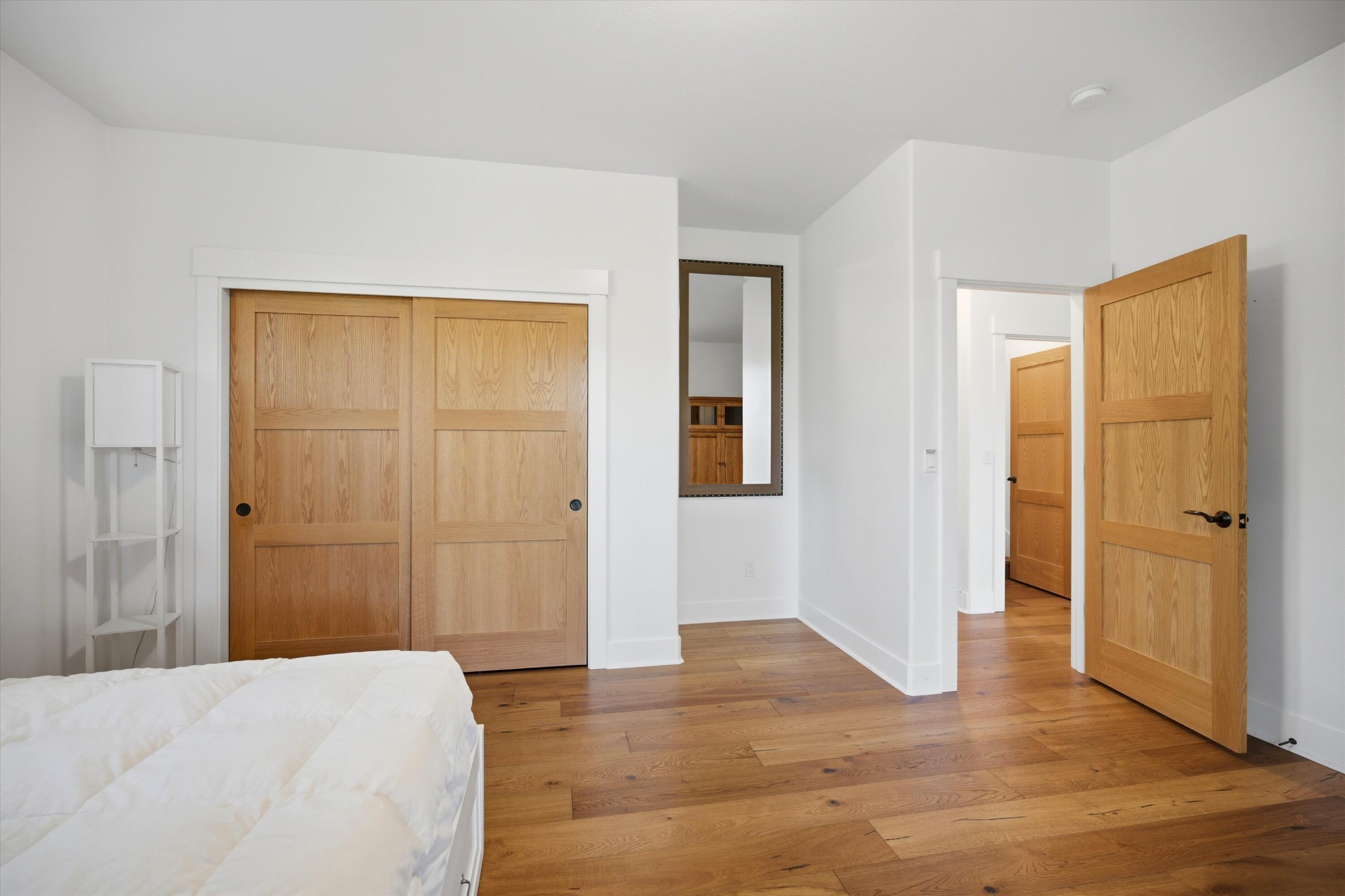 15 Southwest Quail Butte Place Bend, OR 97703 - Photo 40 of 55 a view of bedroom with wooden floor