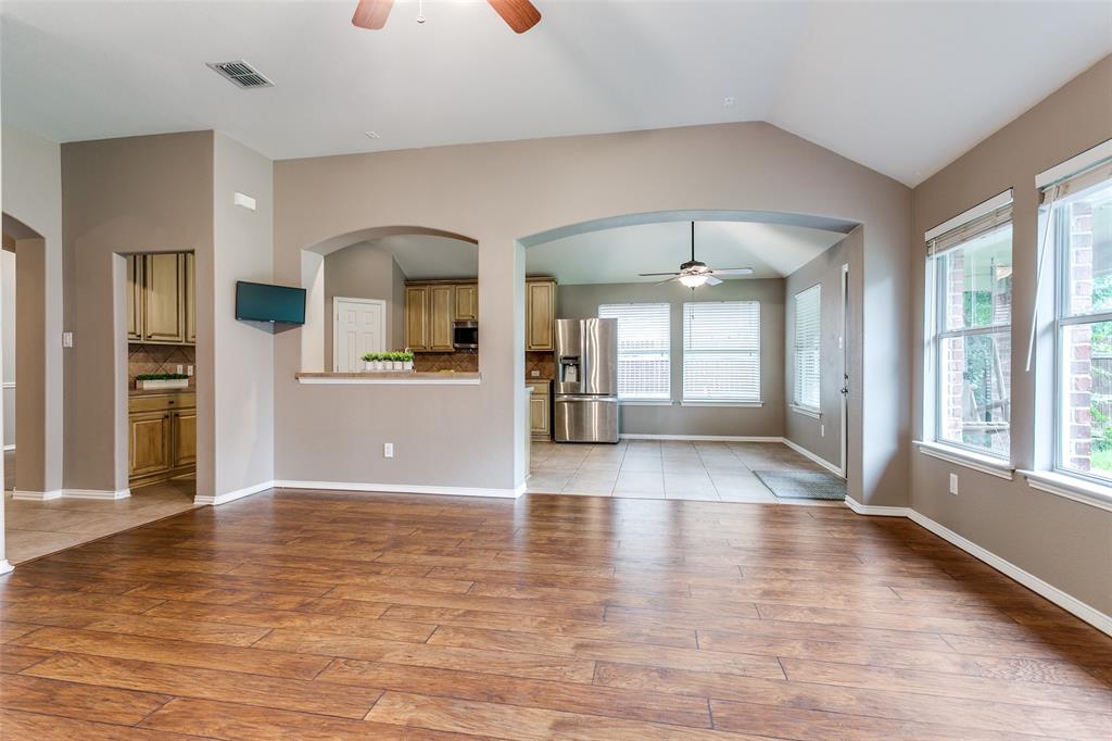 a view of a kitchen with wooden floor and a kitchen