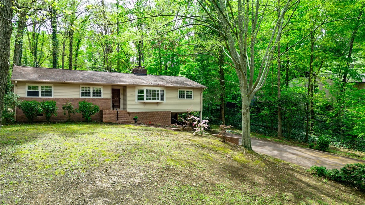 106 Mitchell Avenue Clemson, SC 29631 - Photo 31 of 31 This charming residence offers a serene escape, surrounded by lush greenery and mature trees.