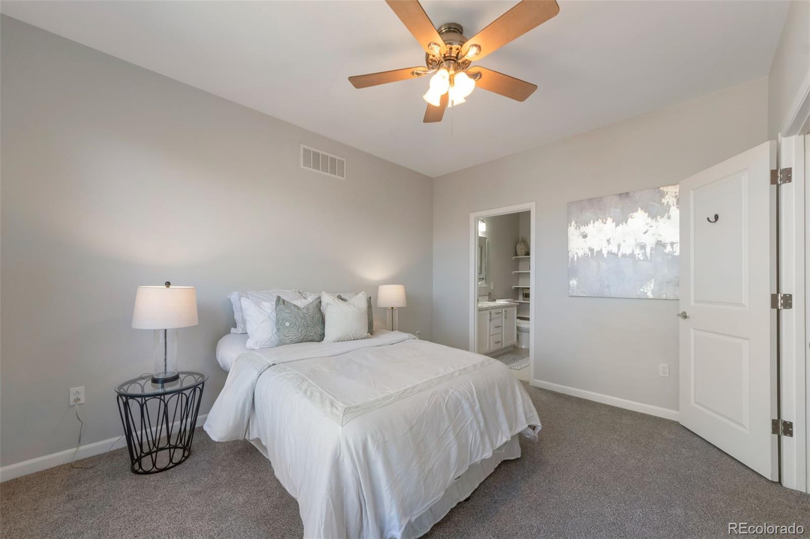 85 Uinta Way, Unit 603 Denver, CO 80230 - Photo 15 of 25 a bedroom with a bed and a chandelier