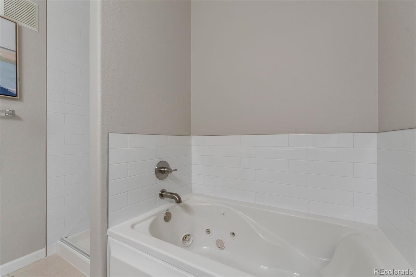 85 Uinta Way, Unit 603 Denver, CO 80230 - Photo 18 of 25 a bathroom with a bathtub