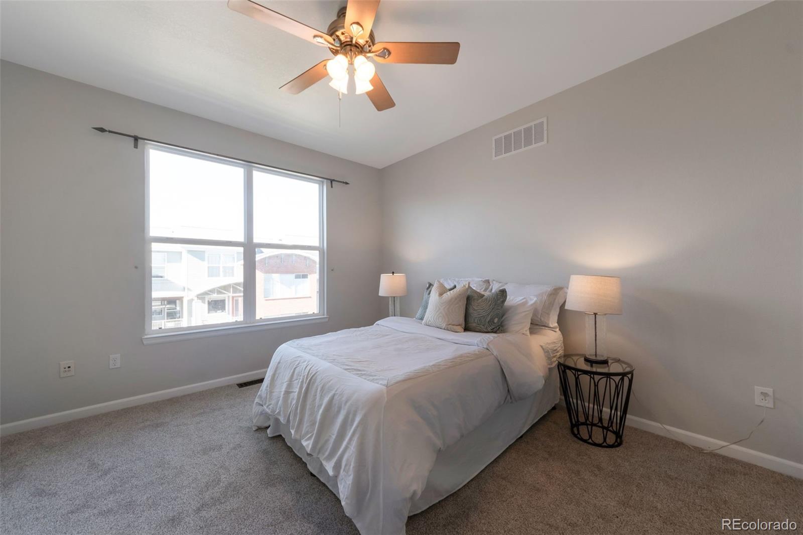 85 Uinta Way, Unit 603 Denver, CO 80230 - Photo 19 of 25 a bedroom with a bed and a chandelier