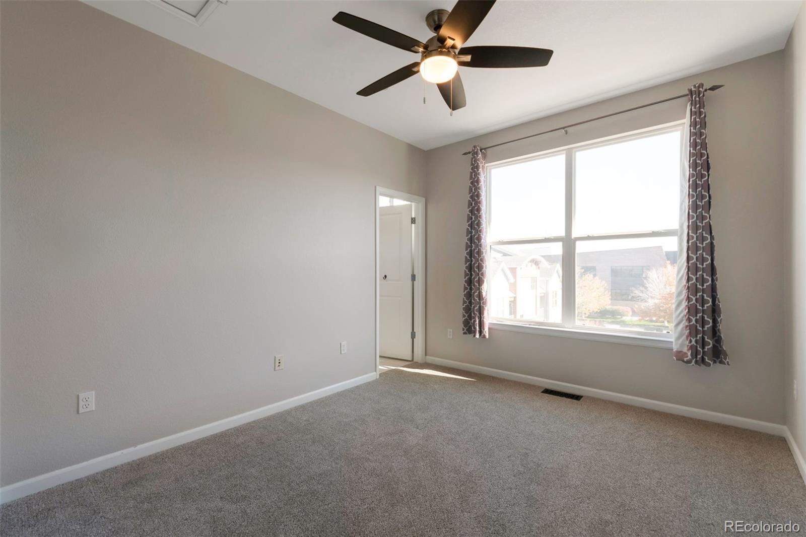 85 Uinta Way, Unit 603 Denver, CO 80230 - Photo 20 of 25 an empty room with a window and a fan