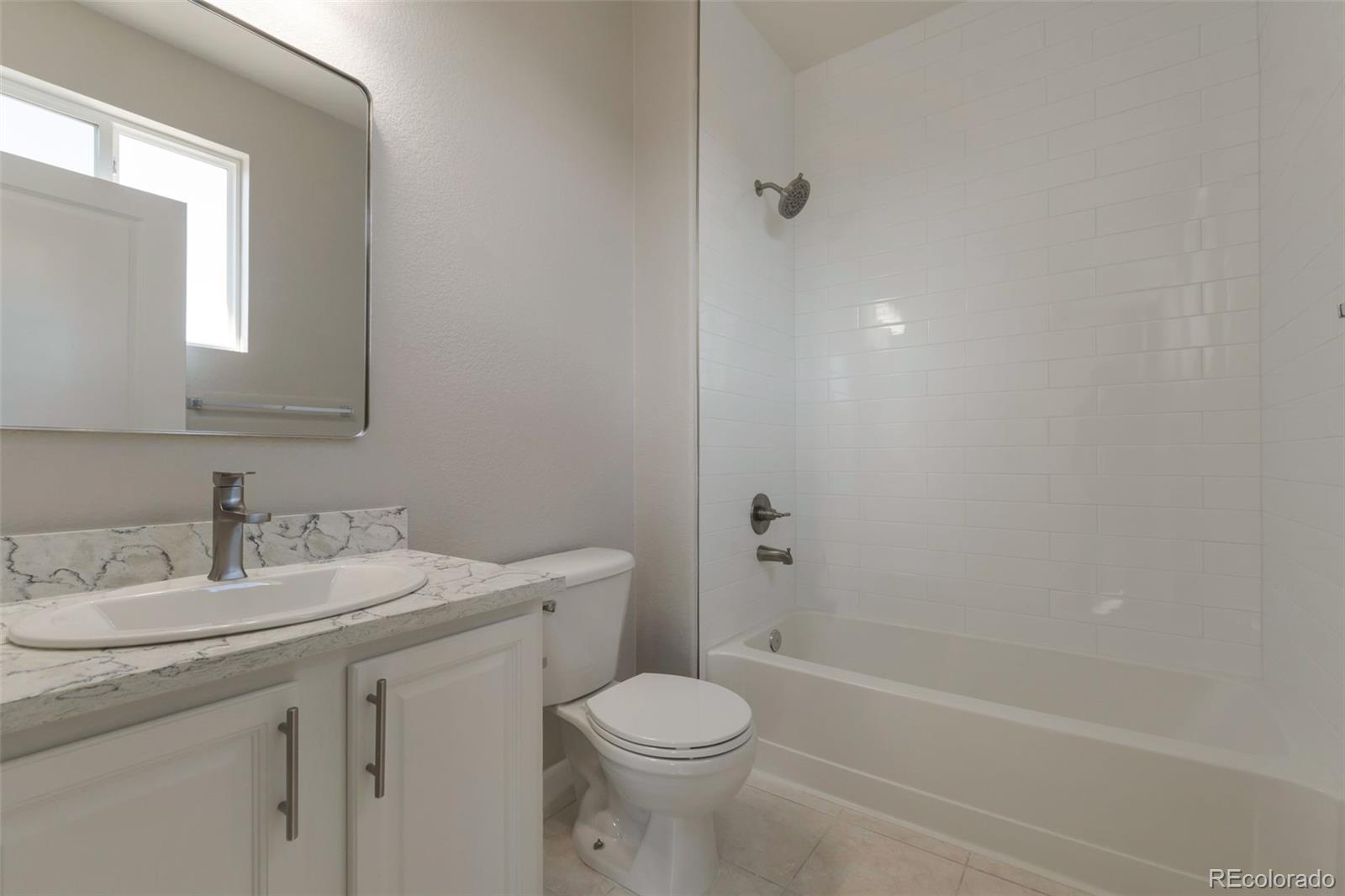 85 Uinta Way, Unit 603 Denver, CO 80230 - Photo 23 of 25 a bathroom with a sink toilet and vanity