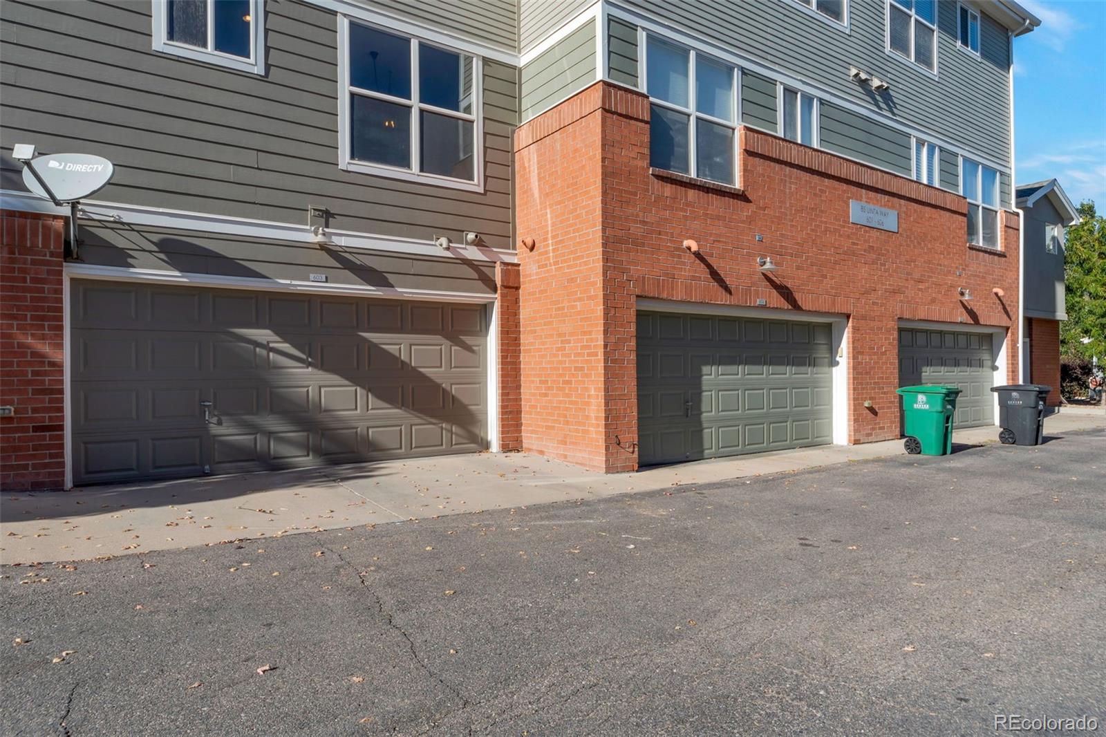 85 Uinta Way, Unit 603 Denver, CO 80230 - Photo 25 of 25 a front view of a house with a yard and garage