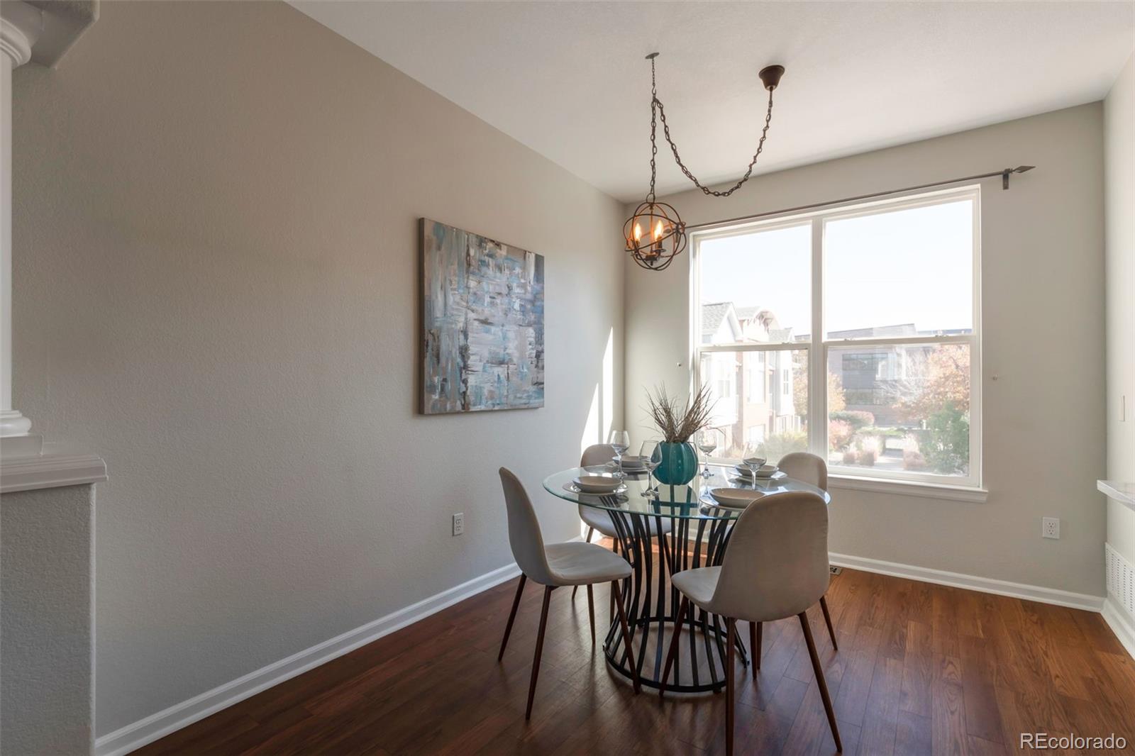85 Uinta Way, Unit 603 Denver, CO 80230 - Photo 7 of 25 a view of a dining room with furniture window and wooden floor