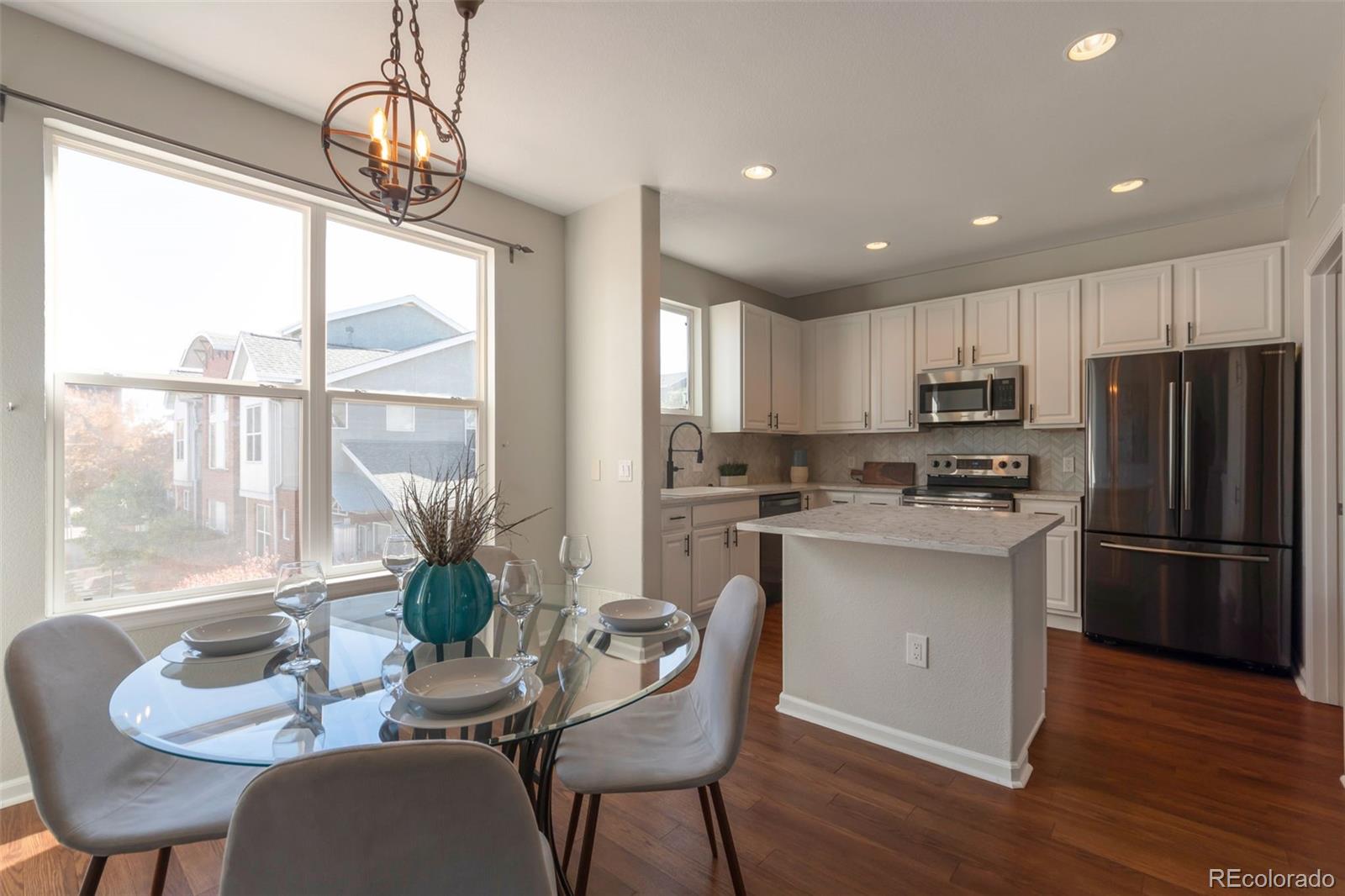 85 Uinta Way, Unit 603 Denver, CO 80230 - Photo 8 of 25 a kitchen with stainless steel appliances granite countertop a dining table and chairs