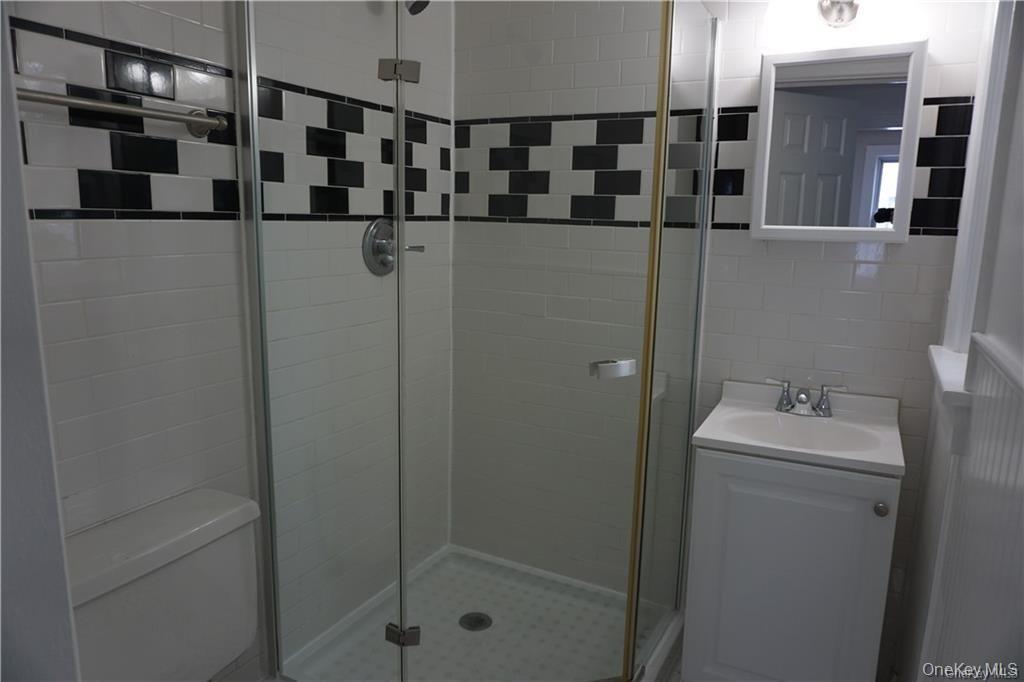 63 Spring Street Mount Kisco, NY 10549 - Photo 11 of 11 a bathroom with a sink toilet and shower