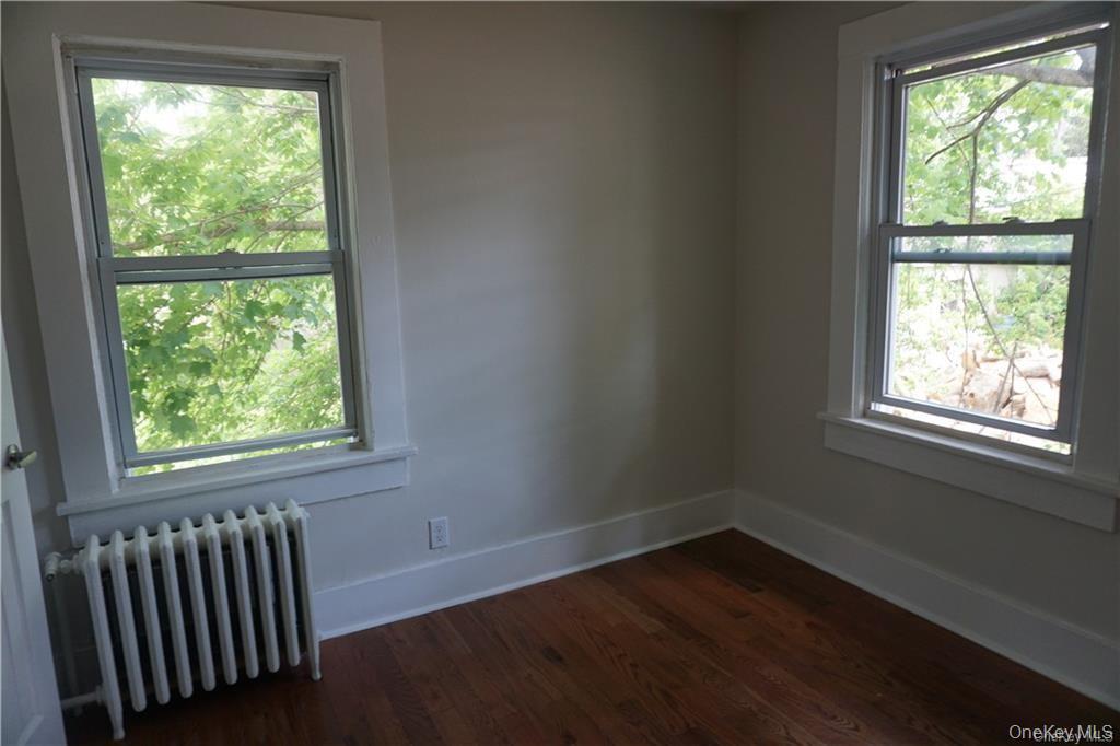 63 Spring Street Mount Kisco, NY 10549 - Photo 7 of 11 a view of an empty room with wooden floor and a window