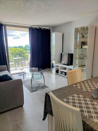 a living room with furniture window and a table