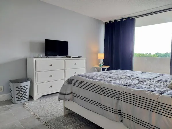 a bedroom with a bed and a flat screen tv