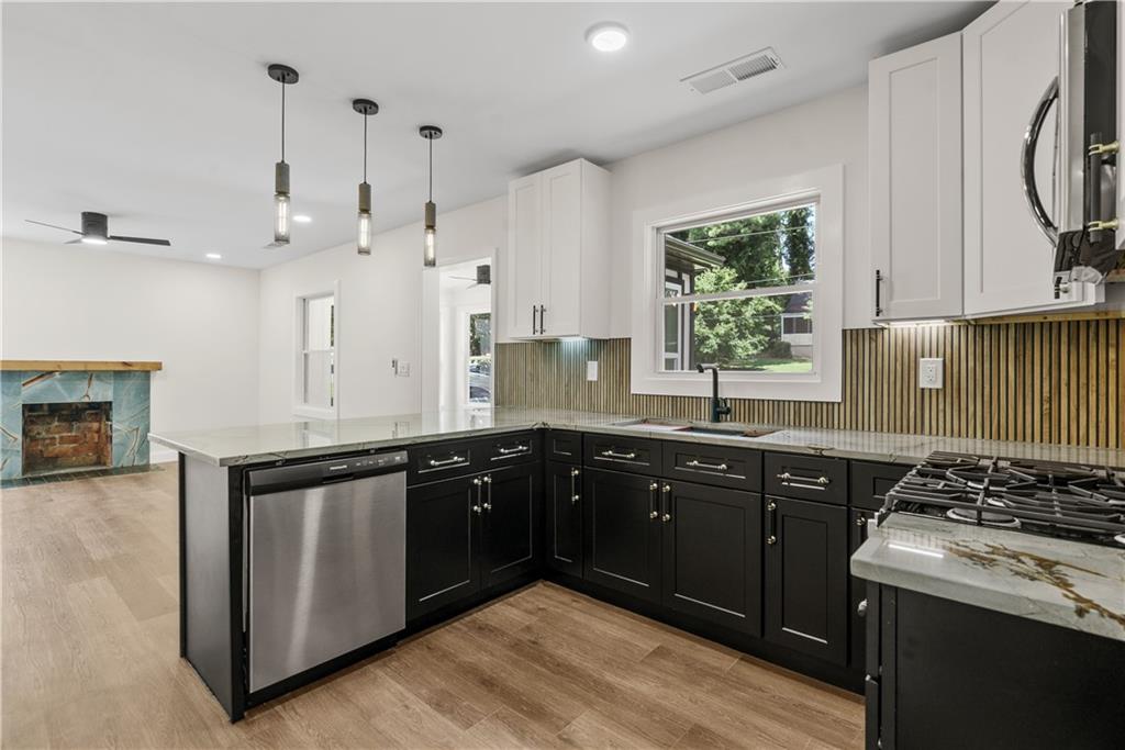 1658 Altadena Place Southwest Atlanta, GA 30311 - Photo 11 of 47 a kitchen with a sink stove and cabinets