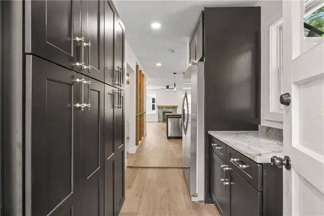 a kitchen with stainless steel appliances granite countertop a refrigerator and a sink
