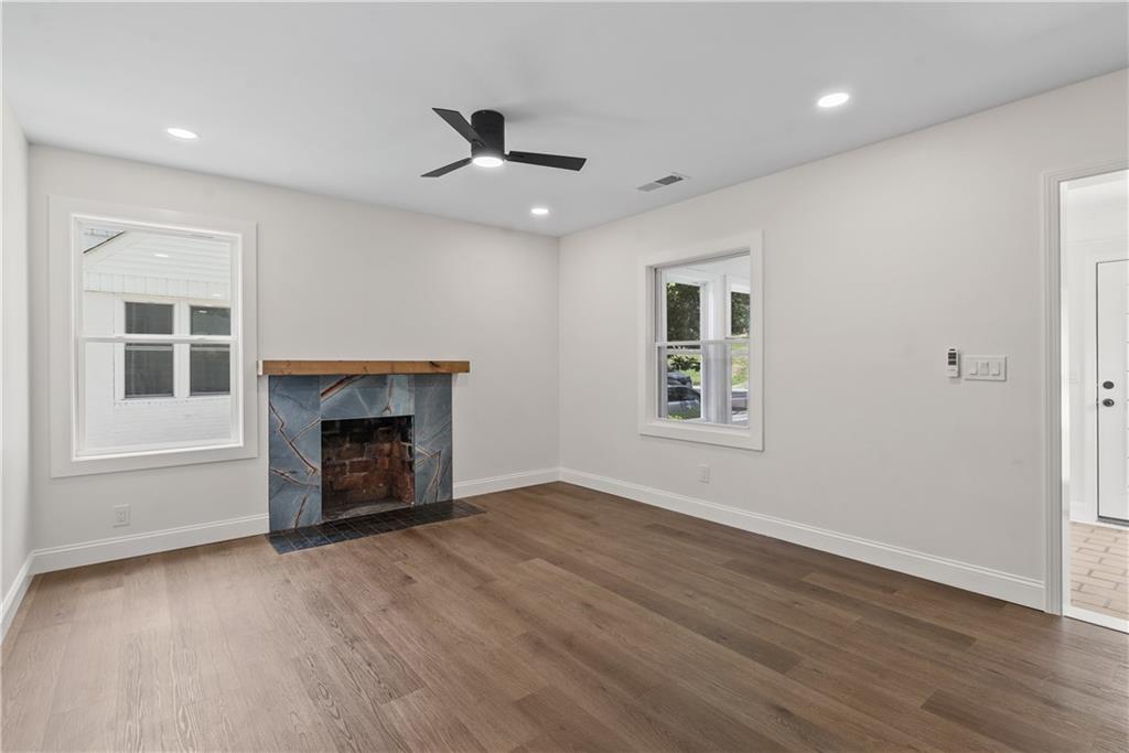 1658 Altadena Place Southwest Atlanta, GA 30311 - Photo 17 of 47 an empty room with windows and fireplace