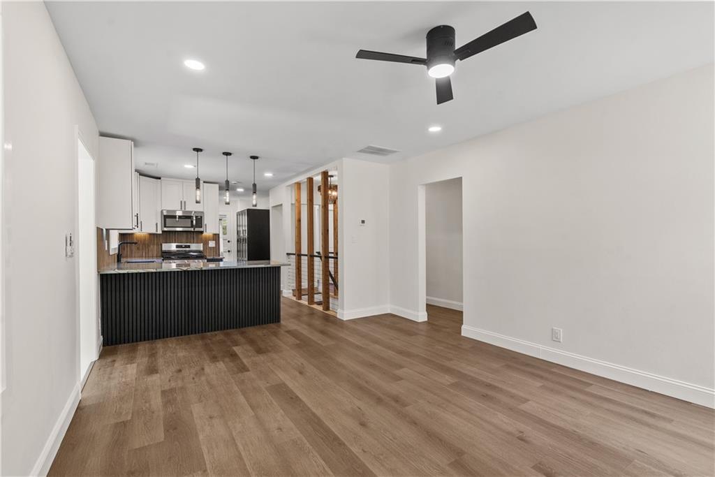 1658 Altadena Place Southwest Atlanta, GA 30311 - Photo 19 of 47 a kitchen with stainless steel appliances a refrigerator and wooden floor