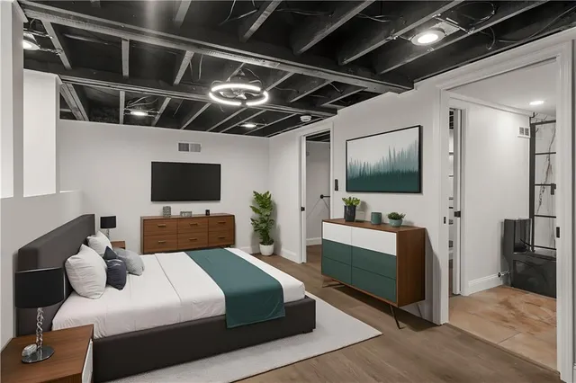 a bedroom with a bed and a flat screen tv