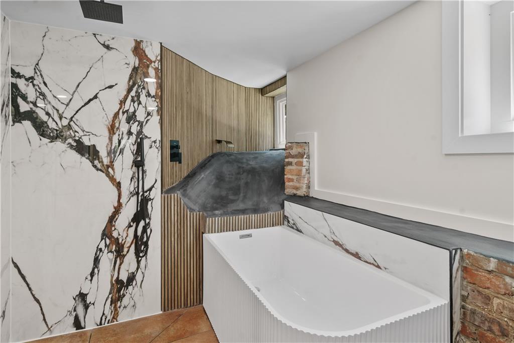 1658 Altadena Place Southwest Atlanta, GA 30311 - Photo 33 of 47 a bathroom with a bathtub and shower