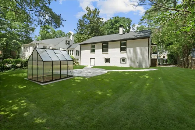 a front view of a house with a yard and porch