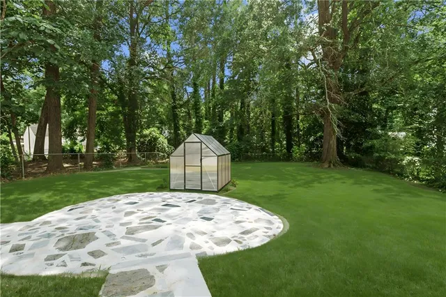 a view of a backyard with a garden and entertaining space