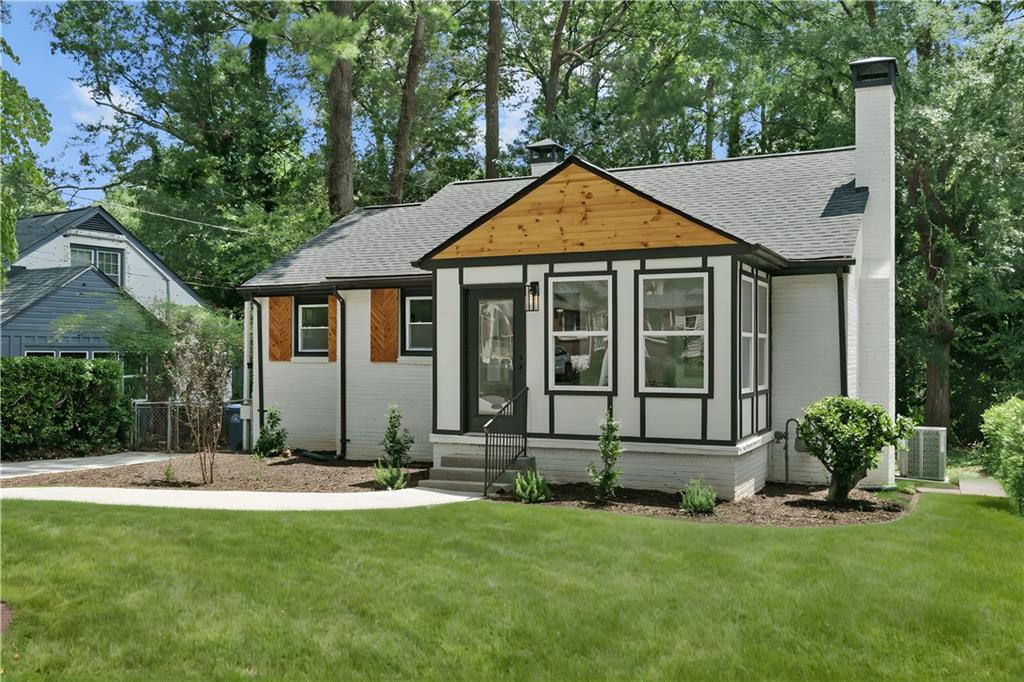 1658 Altadena Place Southwest Atlanta, GA 30311 - Photo 5 of 47 a front view of a house with a yard