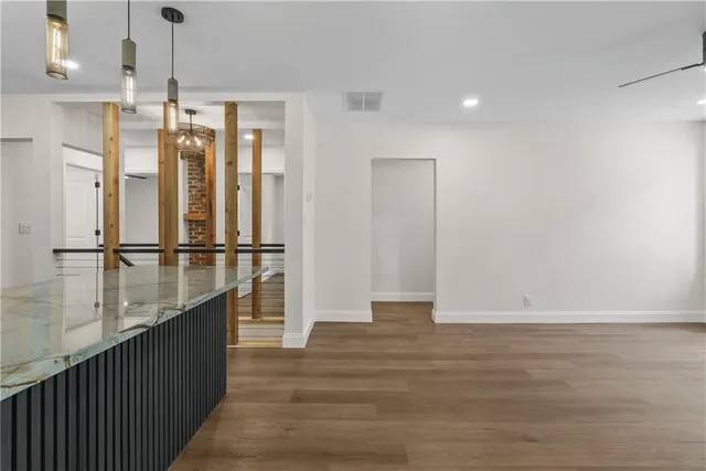 a view of a kitchen with wooden floor and a window