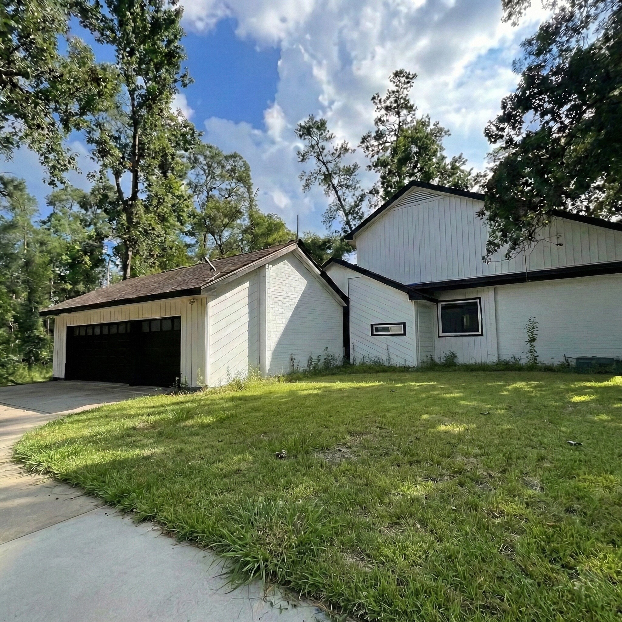 6123 Northway Drive Spring, TX 77389 - Photo 3 of 7 a view of a yard in front of a house with large trees