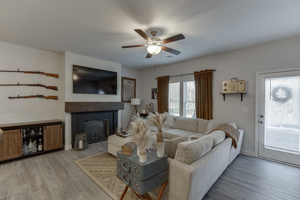 3712 Abbey Way Gainesville, GA 30507 - Photo 12 of 44 a living room with furniture a fireplace and a flat screen tv