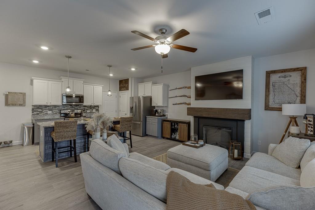 3712 Abbey Way Gainesville, GA 30507 - Photo 13 of 44 a living room with furniture a fireplace and a flat screen tv
