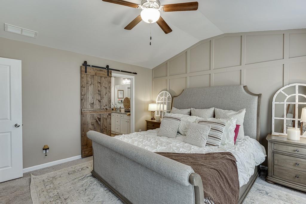 3712 Abbey Way Gainesville, GA 30507 - Photo 17 of 44 a bedroom with a bed and a chandelier