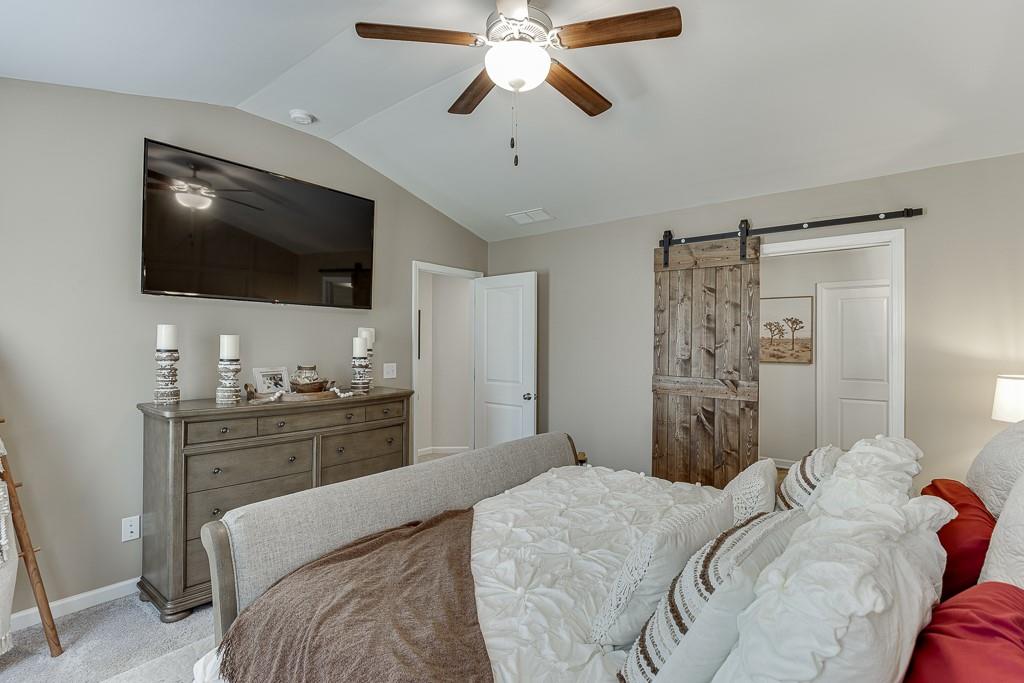 3712 Abbey Way Gainesville, GA 30507 - Photo 19 of 44 a bedroom with a bed and a flat screen tv