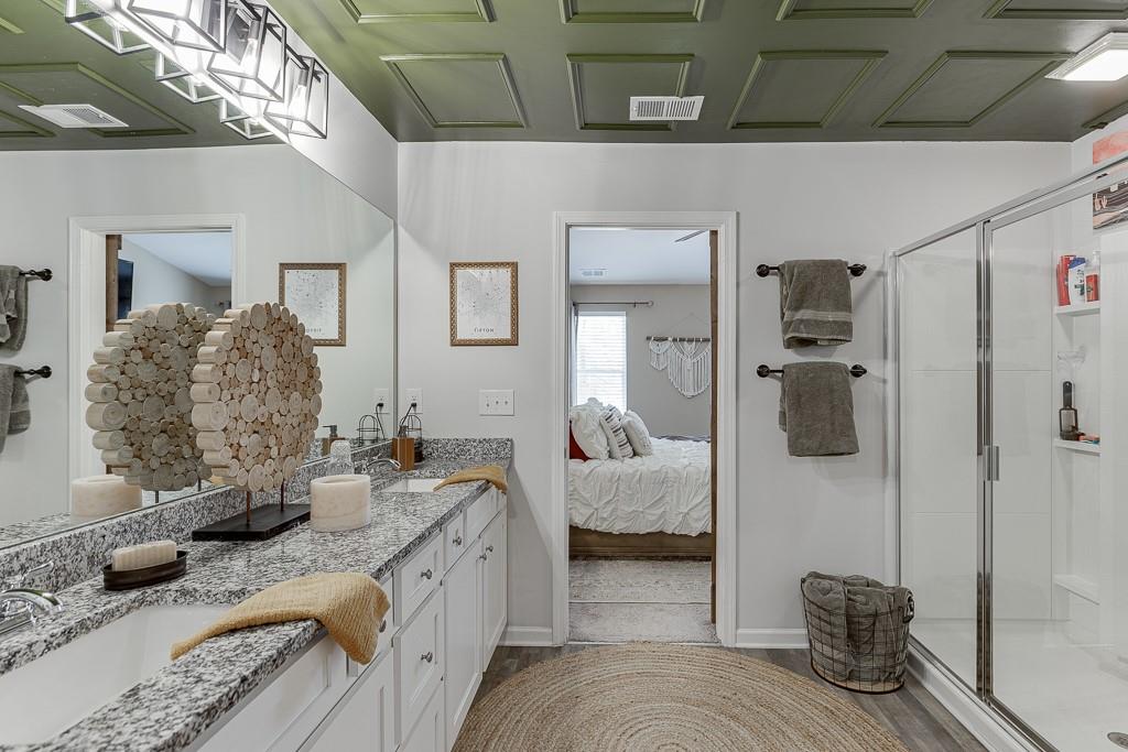 3712 Abbey Way Gainesville, GA 30507 - Photo 25 of 44 a spacious bathroom with a granite countertop shower and a mirror