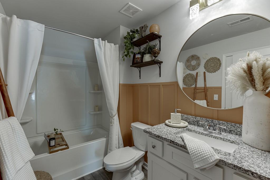 3712 Abbey Way Gainesville, GA 30507 - Photo 26 of 44 a bathroom with a granite countertop bathtub sink vanity mirror and toilet