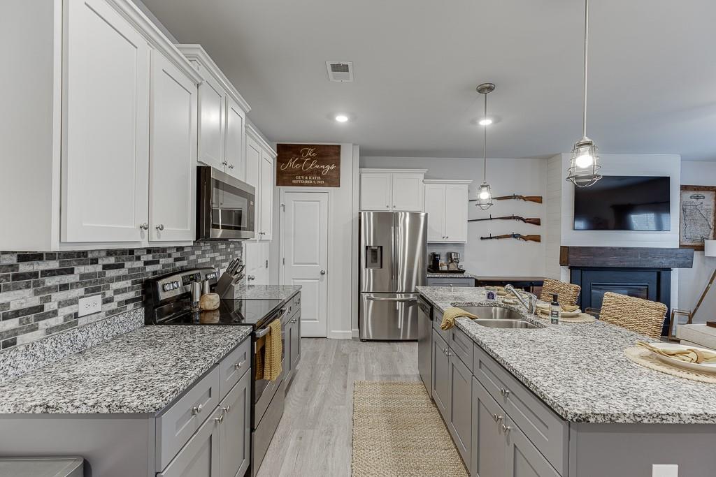 3712 Abbey Way Gainesville, GA 30507 - Photo 7 of 44 a kitchen with stainless steel appliances granite countertop a sink stove and refrigerator