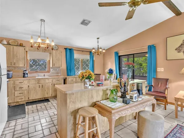 a living room with furniture a chandelier and a table