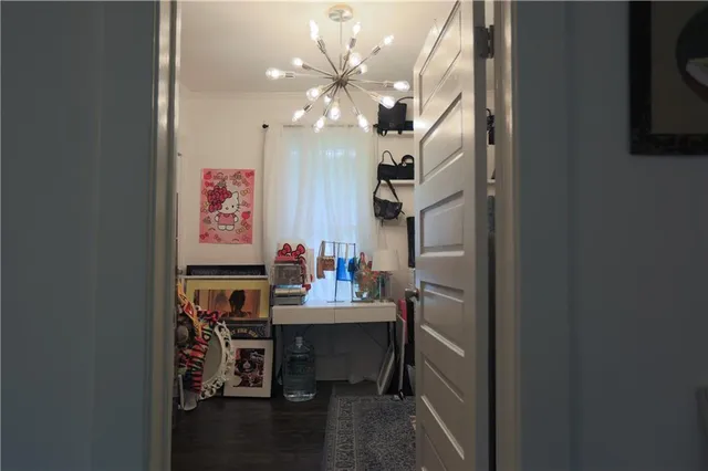 a view of a dining room with furniture and a chandelier fan