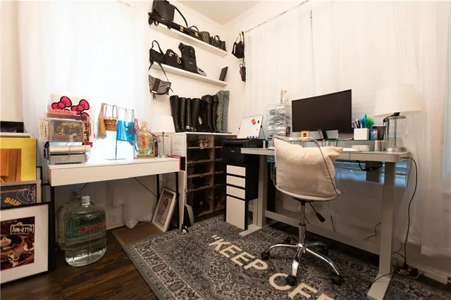 a work room with furniture and a flat screen tv